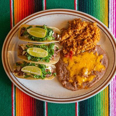 Street Tacos with a side of rice and beans, top view.