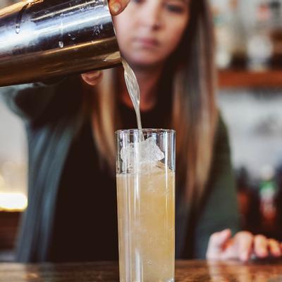 A staff member making a cocktail