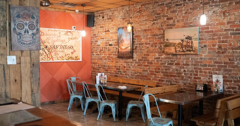 Interior, corner seating area, red brick wall, posters as decoration, lanterns, ceiling fan