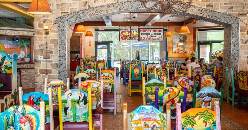 Dining area, colorful chairs and tables