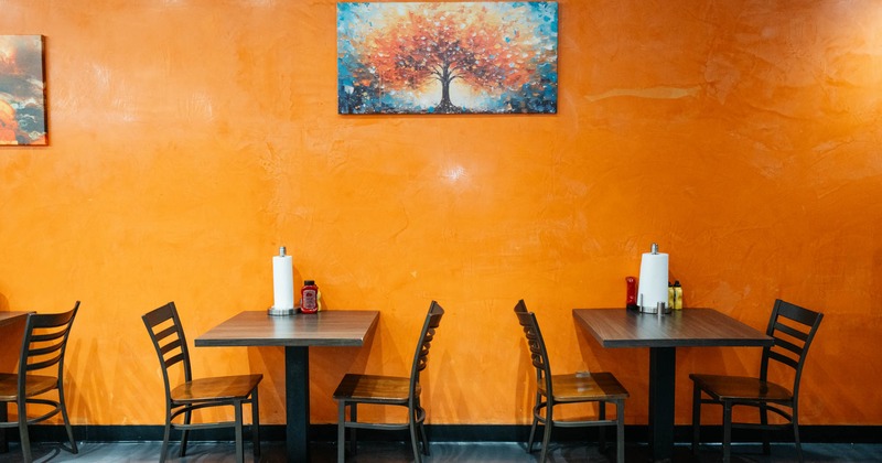 Interior, tables for two, picture on the wall