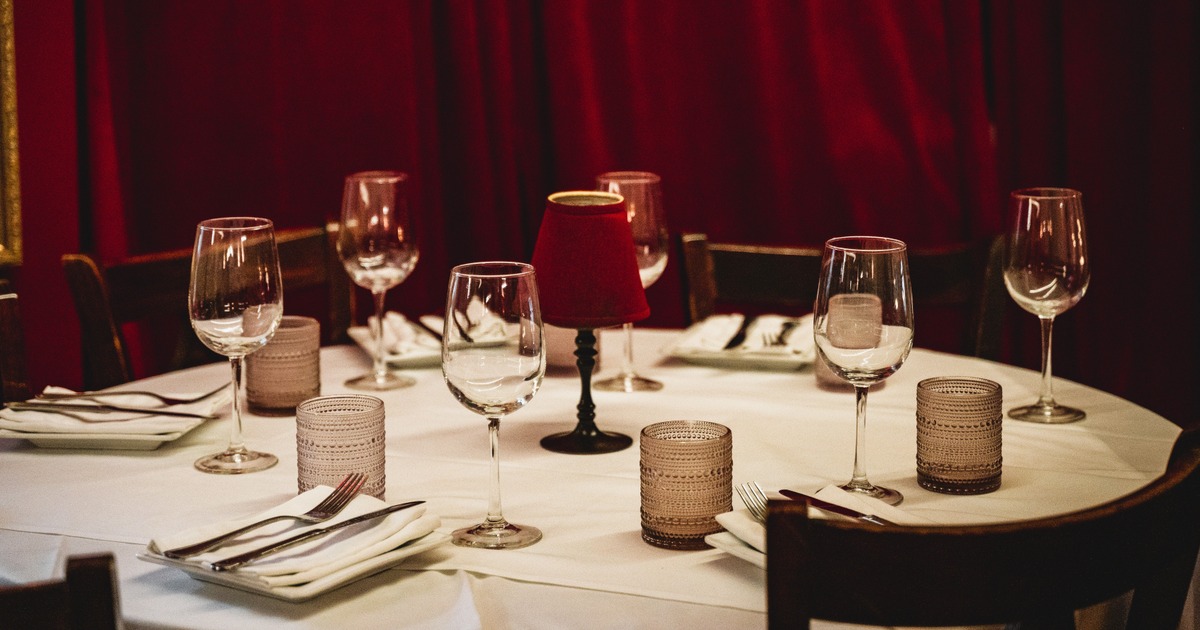 Elegant candlelit table setting for a hosted dinner in the main dining room at Il Sogno Italiano.