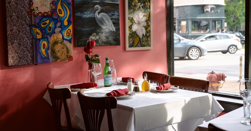 Dining table set for four guests in the restaurant corner by the window