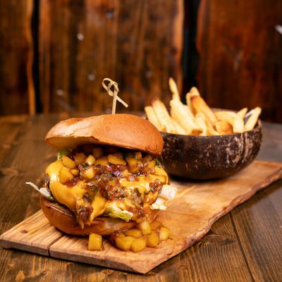 Tropical burger served with fries.
