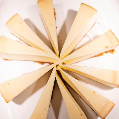 Overhead view of cheesecake slices arranged in a circular pattern.