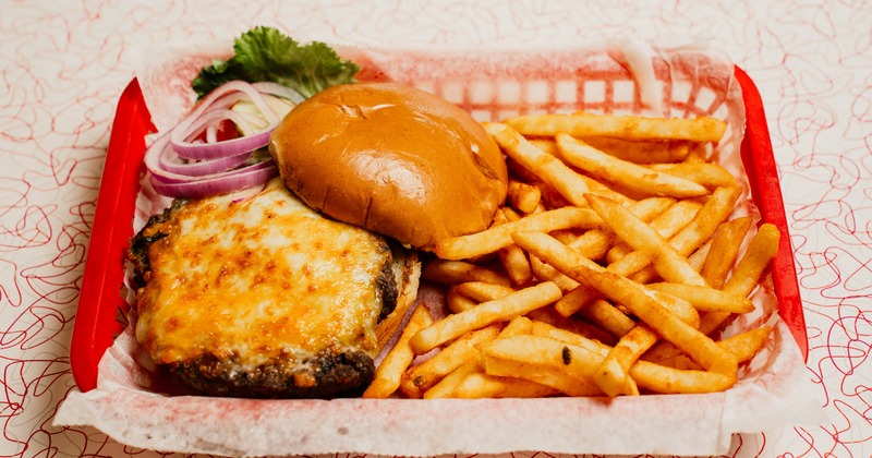 Badger Burger served in a red basket lined with paper with a side of fries