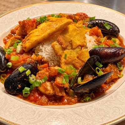 Enchilado de mariscos: mixseafood, blackbeans, maduros, white rice, creole sauce.