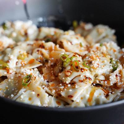 Chicken and chili dumplings topped with scallions and cotija cheese.