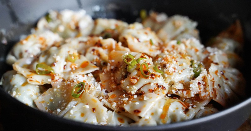 Chicken and chili dumplings topped with scallions and cotija cheese