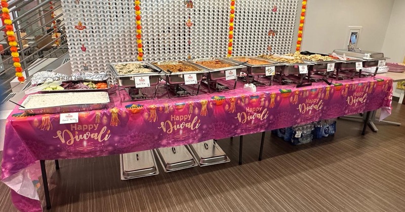 Interior, a long buffet table set with chafing dishes and plates