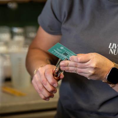 Staff member stamping a loyalty card for a customer.