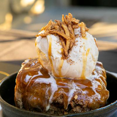 Cinnamon Bread Pudding with ice cream scoop on top.