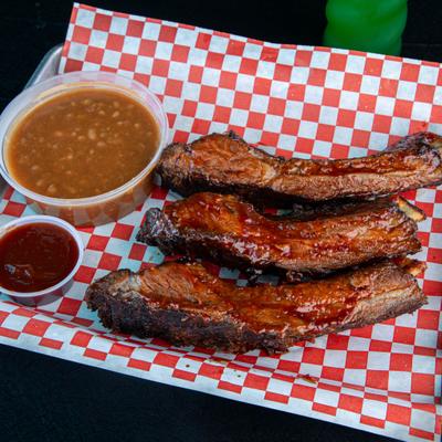BBQ platter with smoked ribs, black beans and a dipping sauce.