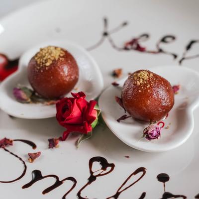 Fried dough balls soaked in a sweet, sticky sugar syrup.