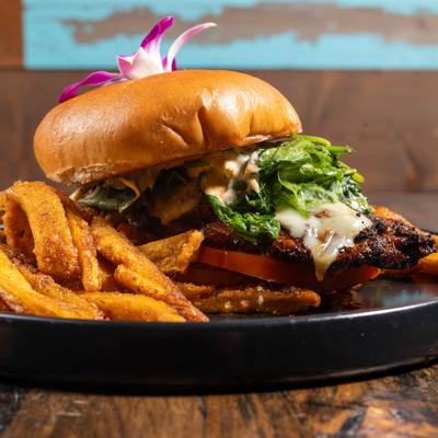 Caribbean blackened chicken sandwich with fries.