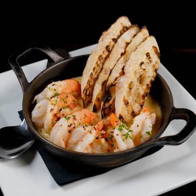 Cast Iron Shrimp, with white wine and garlic butter sauce, and bread.