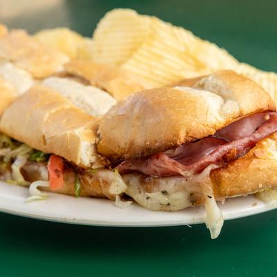 Whole Italian Hoagie sandwich served with chips on the side.