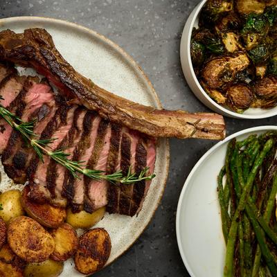 Rib eye steak with roasted potatoes and broccolini, grilled asparagus and roasted Brussels.