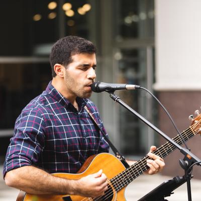 Outdoors, musician performing in patio.