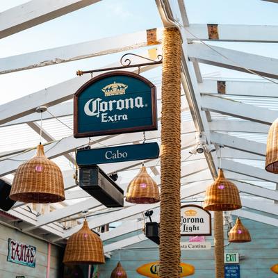 Open air patio with wicker lighting and a Corona sign