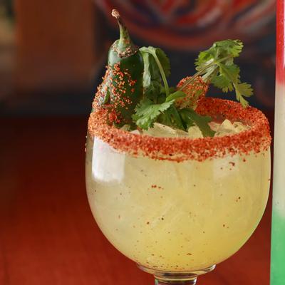 Jalapeno Margarita with Spiced rim, jalapeno, and cilantro garnish, close up