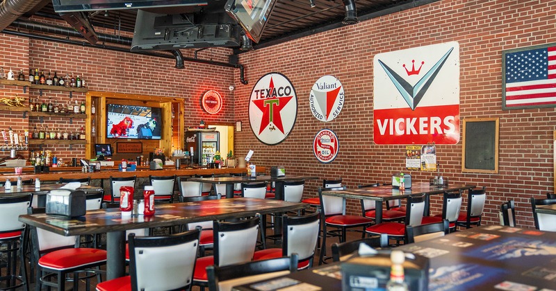 Interior space, dining area with lined up tables and a bar