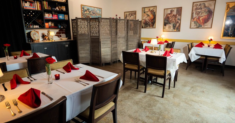Interior, tables in dining area set for guests