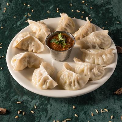 Steamed chicken dumplings served with tomato chutney.
