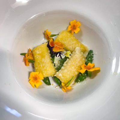 Primavera Agnolotti - Lemon ricotta, artichoke, spinach stuffed agnolotti, sauteed sweet peas and shaved parmesean.