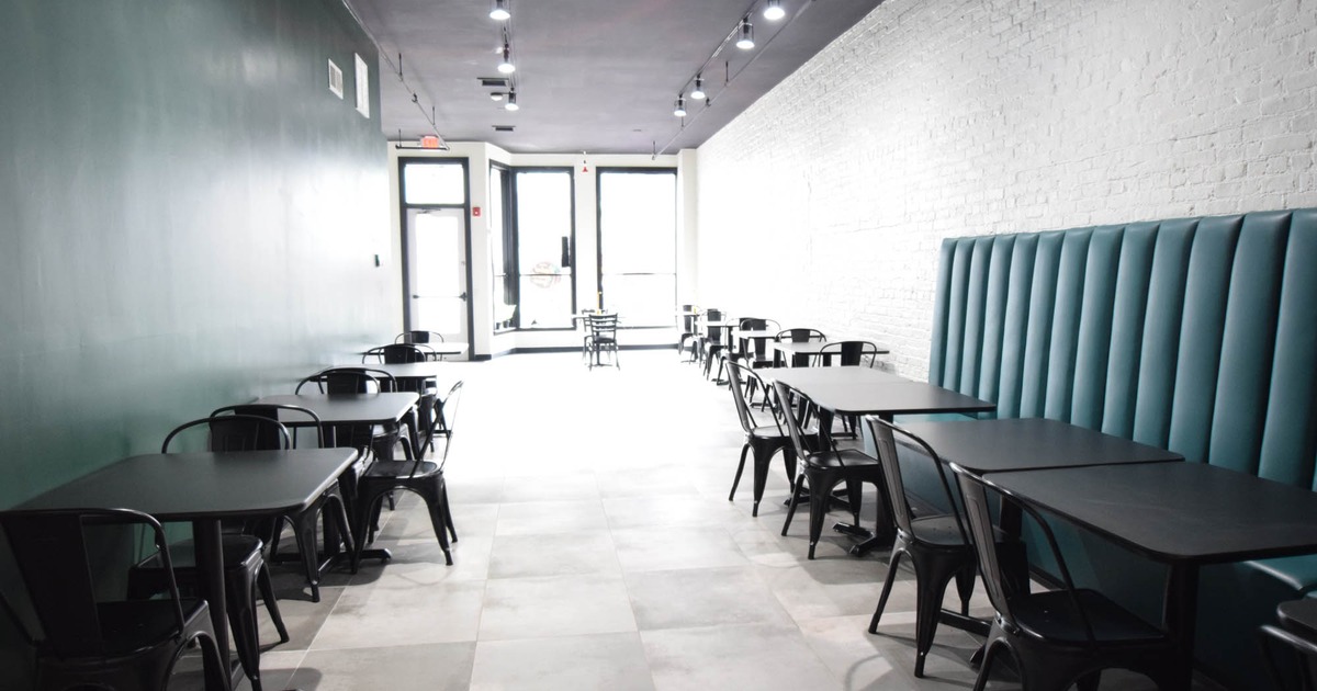 Interior, dining area, tables with chairs, long banquette bench with tables and chairs