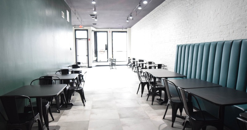 Interior, dining area, tables with chairs, long banquette bench with tables and chairs