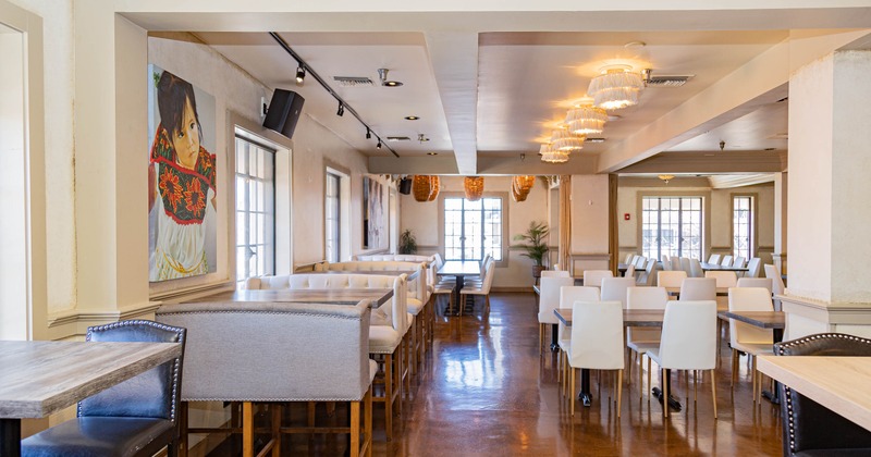 Interior of a bright, spacious restaurant with booth and chair seating