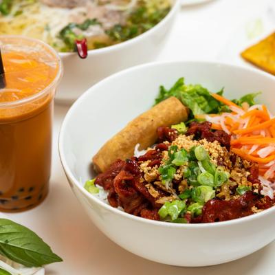 Rice vermicelli bowl topped with pork BBQ, cruched peanuts and shreded vegetables.