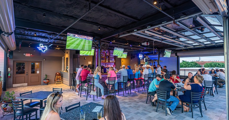Exterior, patio, bar, tables, chairs, people