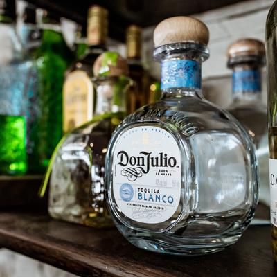 Bar shelf with a selection of tequila bottles.