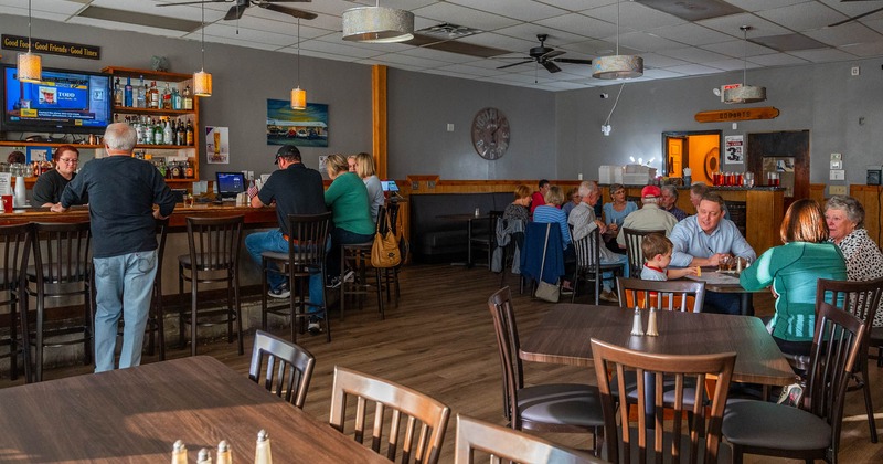 Interior, dining area, tables and chairs, guests sitting and chatting