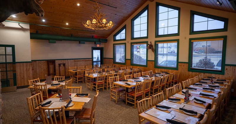 Spacious and cozy interior dining area with set tables, perfect for any private event