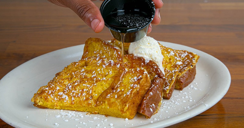 Hands preparing the chicken burrito