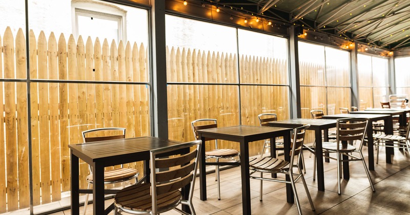 Exterior, covered patio with garden chairs and tables