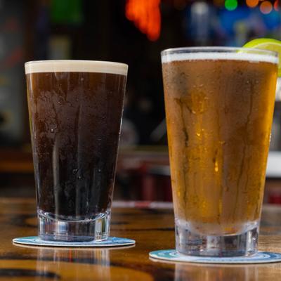 Two different types of beer served on the table.