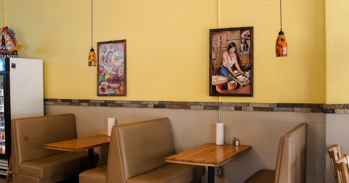 Upholstered booths along the wall