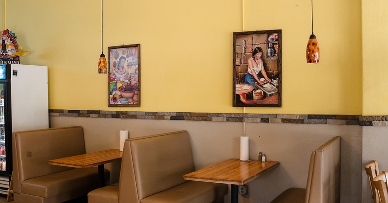 Upholstered booths along the wall