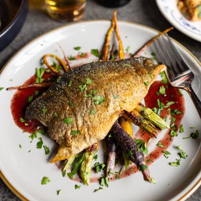 grilled trout with red sauce and roasted carrots