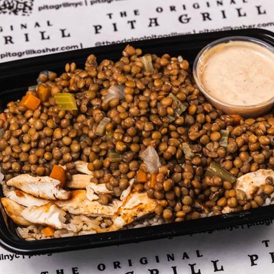 Grilled chicken with lentils and dipping sauce.