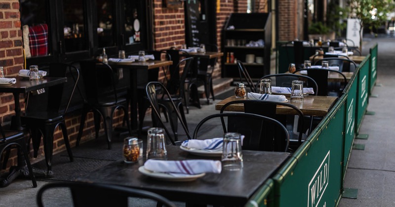 Exterior, tables and chairs with glasses and tableware