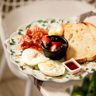 Breakfast Platter with fried eggs, bacon, toast, jam and fresh berries.