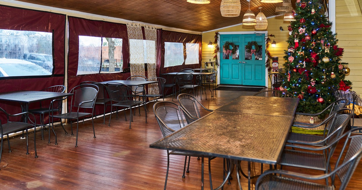 Exterior, patio, dining area, tables with chairs, wooden floor, Christmas tree
