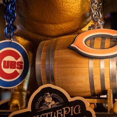 Chains with sport club's visuals hanging from the pig statue.