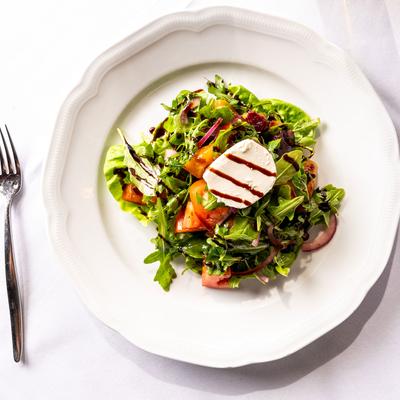 Salad with arugula, tomato, red onion, mozzarella, and balsamic.