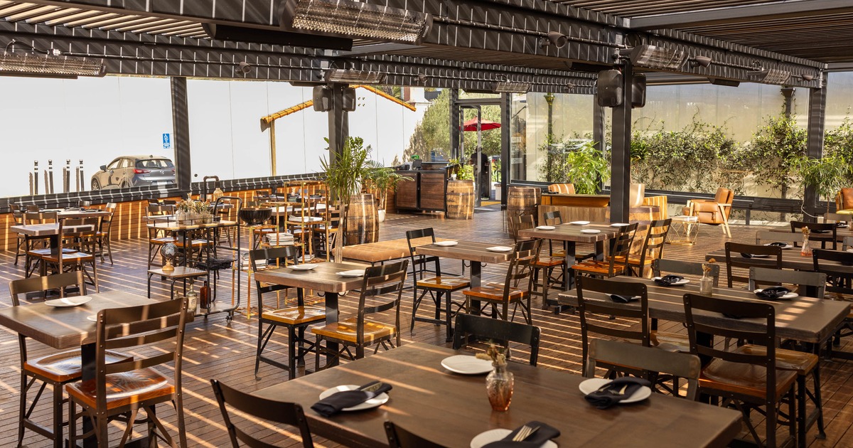Spacious modern restaurant with wooden floors and large windows